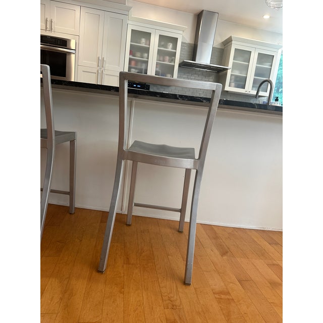 A set of three iconic Philippe Starck counter stools for Emeco in hand-brushed aluminum. We purchased these stools new...