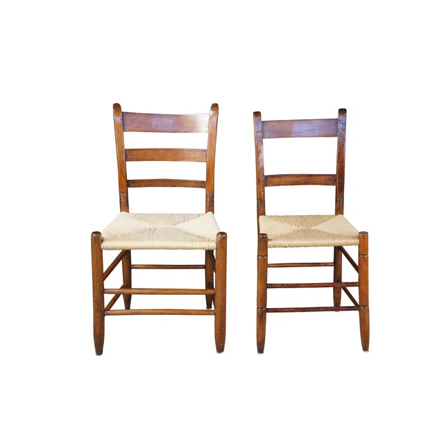 Antique Shaker style his and hers side dining chairs featuring maple frames with ladderback design and woven rush seats....
