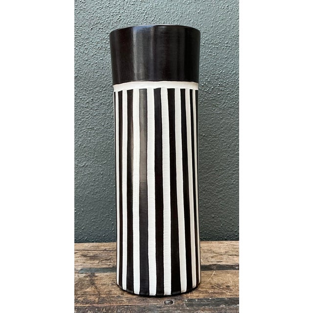 This striking original ceramic vase is a masterclass in graphic minimalism. Featuring a bold vertical stripe pattern...