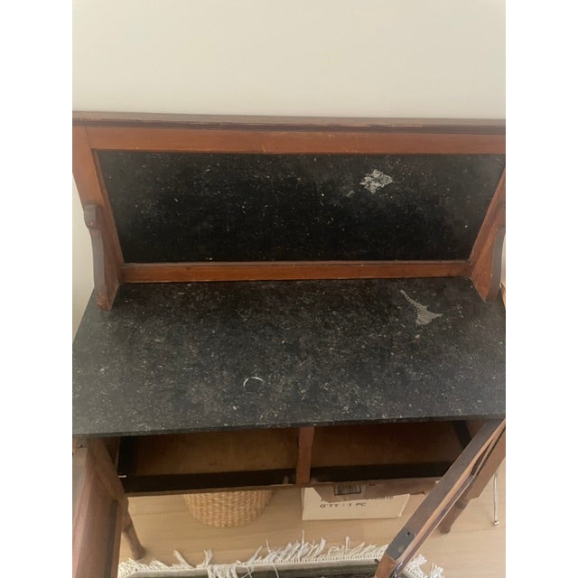 American Washstand ca. 1890-1900, possibly maple with black marble top a splash board, double doors for cupboard below,...