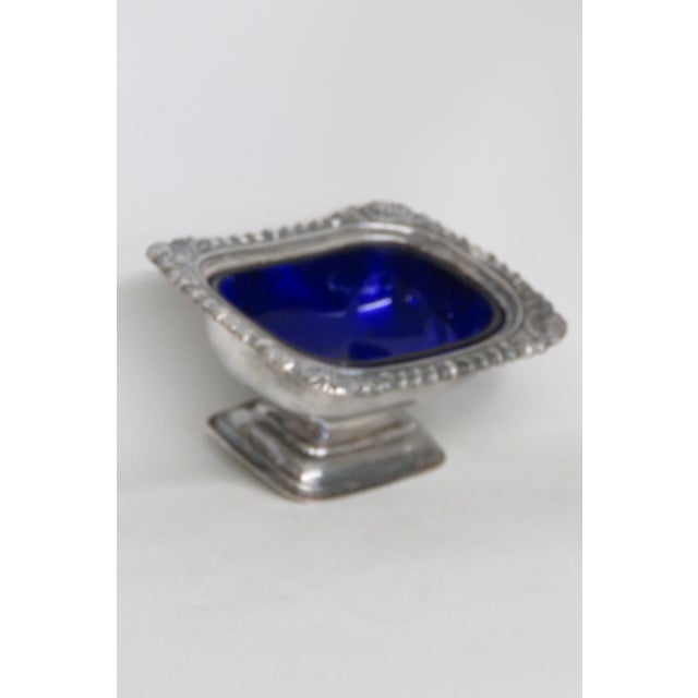 This wonderful salt cellar dish is made of glass and metal. This piece is stamped as being made in England by William...