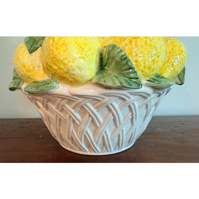 This is a classic Italian lemon topiary in a white basketweave basket. Bright and cheery decor for a kitchen or sunroom.
