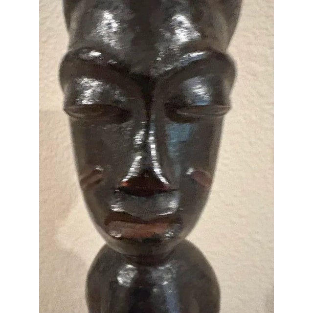This hand carved male figure standing has been created by the Fang people of central Africa, possibly Cameroon. With a...