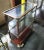 Antique early 20th century, shallow wood and glass, two tiered showcase with wood frame, glass panes, and sliding back...