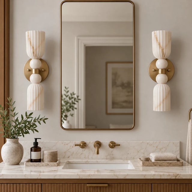 Make a refined statement with this handcrafted pair of brass wall sconces, featuring sculpted ribbed alabaster shades,...