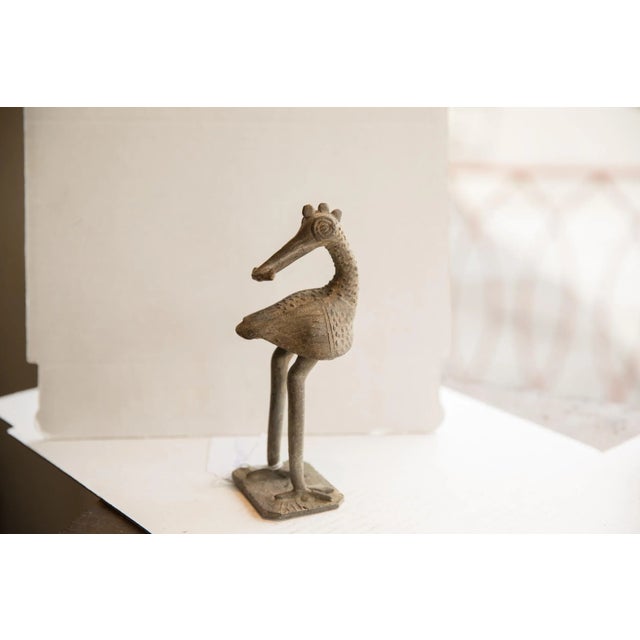 :: Vintage handmade African backwards facing bird sculpture. Circa late mid 20th century, though possibly older, this...