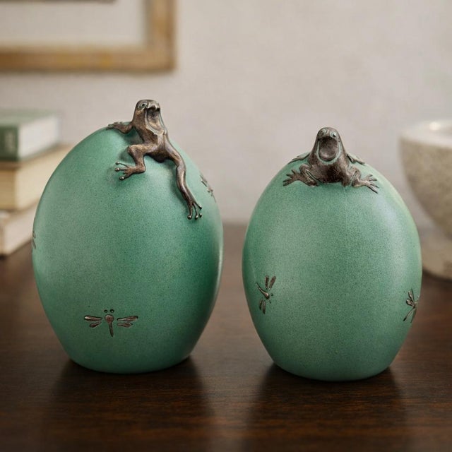 A charming and highly collectible pair of salt and pepper shakers designed by Emilia Castillo, handcrafted in celadon...