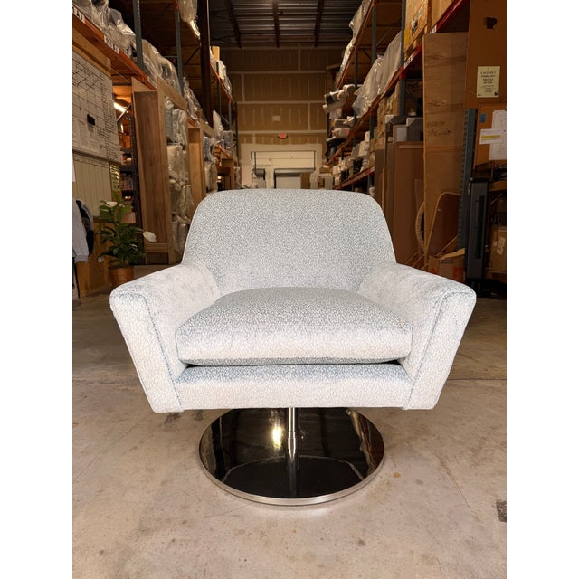 Contemporary swivel accent chair featuring a graceful curved silhouette and clean, tailored lines that bring effortless...