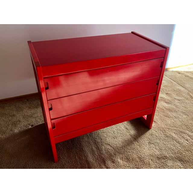 Exceptionally rare modern three-drawer dresser in bright red that perfectly embodies the warm colours, soft lines, and...