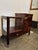 Very nice bar cart from the 30s on wheels Walnut veneer, with sliding glass doors (on both sides). a drawer and with a...