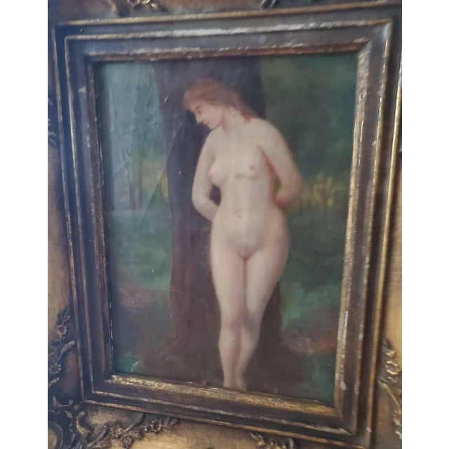 Delicate antique French Rococo oil painting depicting a graceful female nude standing beside a tree in a lush forest...