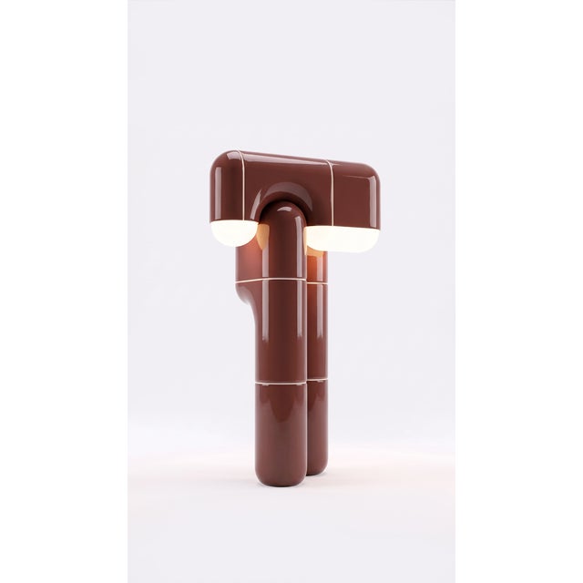 Part light, part totem. This tall table lamp stacks the collection's curved-tile module into a slender column that draws...