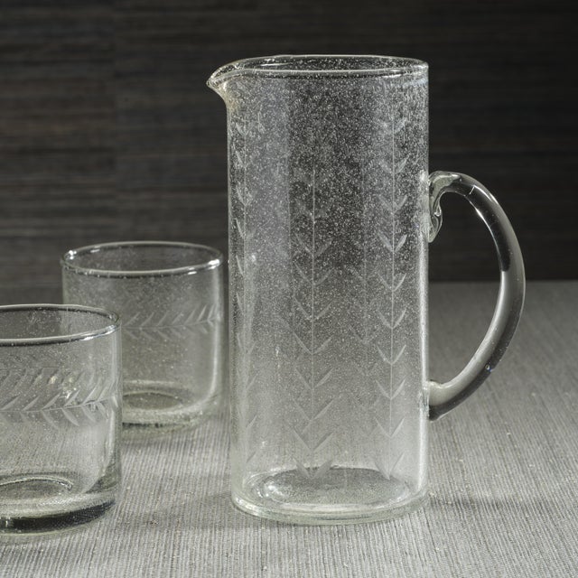 A true work of art, this Tuscan Handmade Etched Glass Pitcher combines sustainable craftsmanship with timeless elegance....