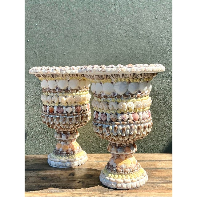 Exuding a timeless coastal allure, this exquisite pair of vintage shell-encrusted urns captures the essence of classic...