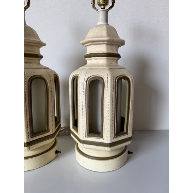 Striking pair of 1970s Hollywood Regency table lamps inspired by classic Palm Beach and Pagoda-style design. Crafted in...