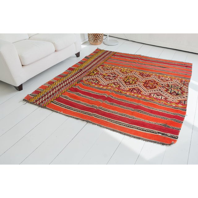 This is a vintage Turkish Oushak rug from the Mid 20th Century. The piece was hand-knotted.