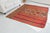 This is a vintage Turkish Oushak rug from the Mid 20th Century. The piece was hand-knotted.
