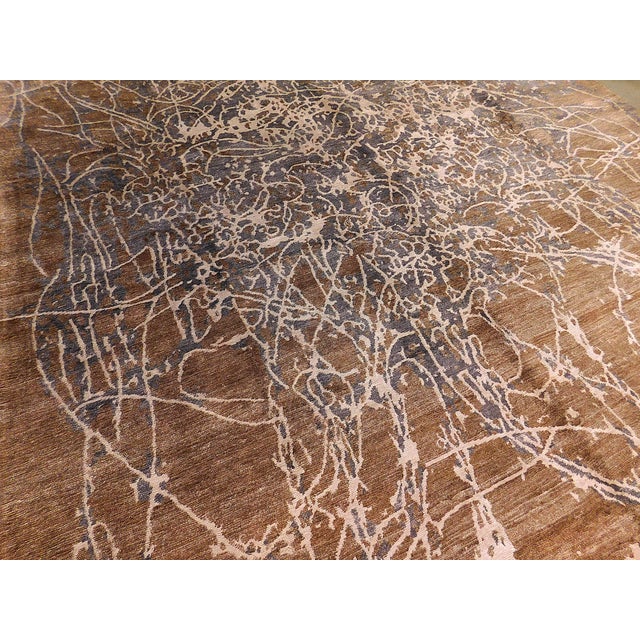 The lush brown bamboo silk pile on cotton foundation, displaying an abstract work of art in grey and white.