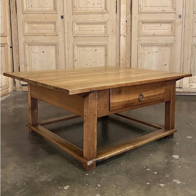19th Century Rustic Country French Fruitwood Coffee Table is a charming ode to the bygone era of lovingly hand-crafted...