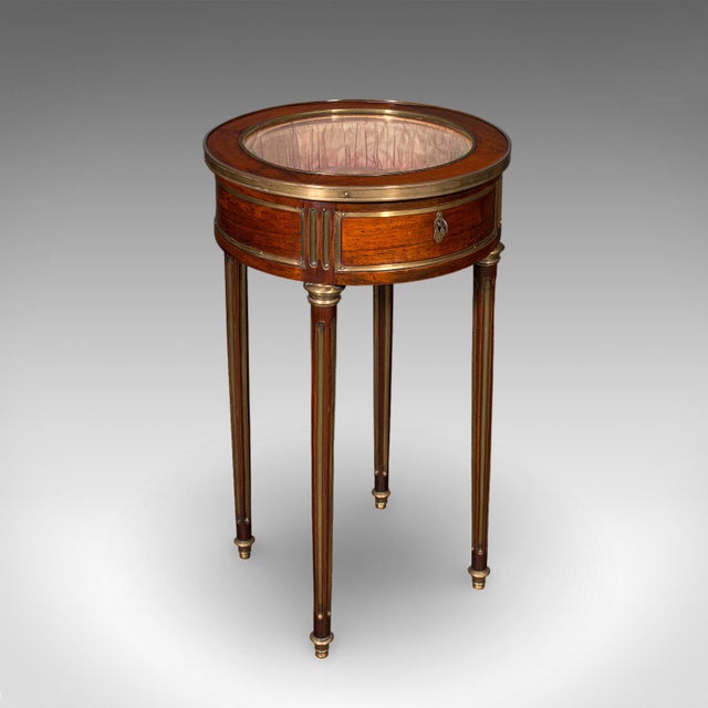 This is an antique Bijouterie table. A French, kingwood and brass glazed display vitrine, dating to the Victorian period,...