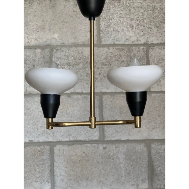 A wonderful ceiling light or pendant from Sweden circa 1950s. Great form with slight curving movement to arms. A fun and...