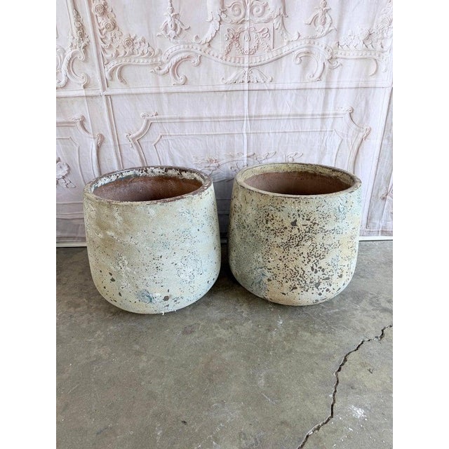 Pair of oversized weathered terra cotta planters, circa 1970-1990, with exceptional pitted limestone finish. Cylindrical...