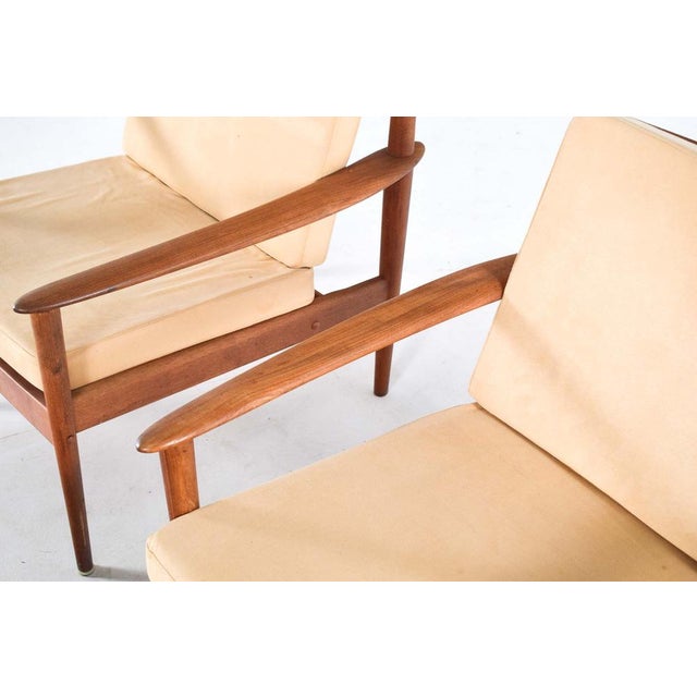 Pair of Teak Armchairs by Grete Jalk with bench. One of the chairs is higher than other. One for man and another for...