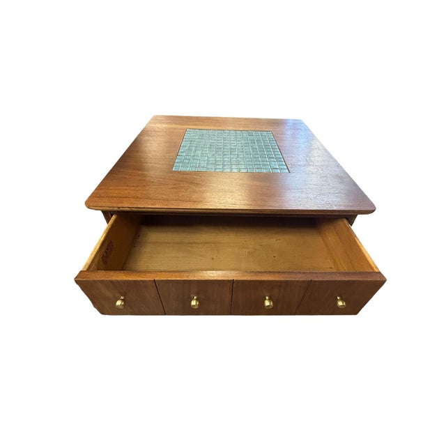 Beautiful mid-century coffee table by Lane Furniture, featuring a center drawer with brass drawer pulls, tapered legs with...