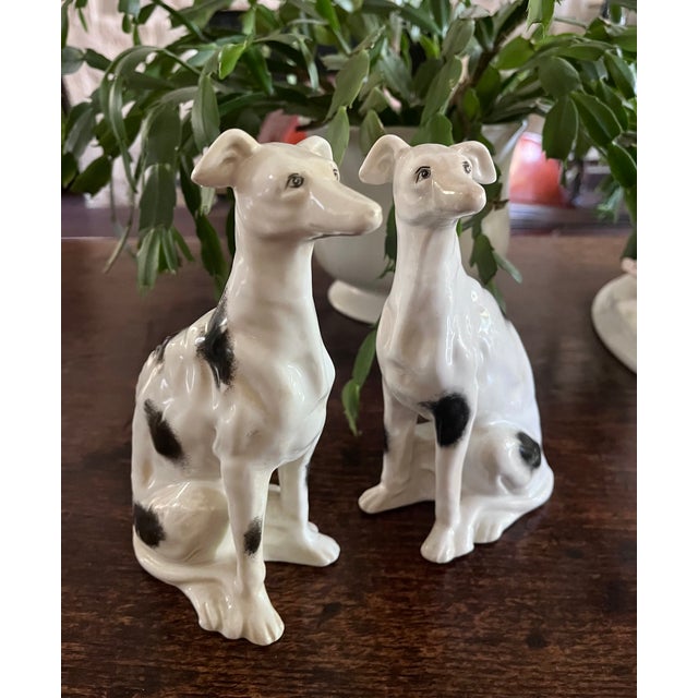 Exquisite pair of vintage porcelain sighthound figurines by the revered luxury home furnishings brand, Maitland-Smith....