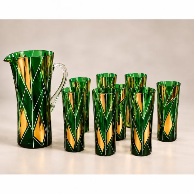 An exquisite vintage mid-century cocktail set featuring a striking emerald-green glass jug and matching tall tumblers,...