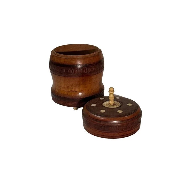 A round wooden box from India. Might be some type of exotic rosewood. Circa 1920s, maybe a little earlier. Box with six...