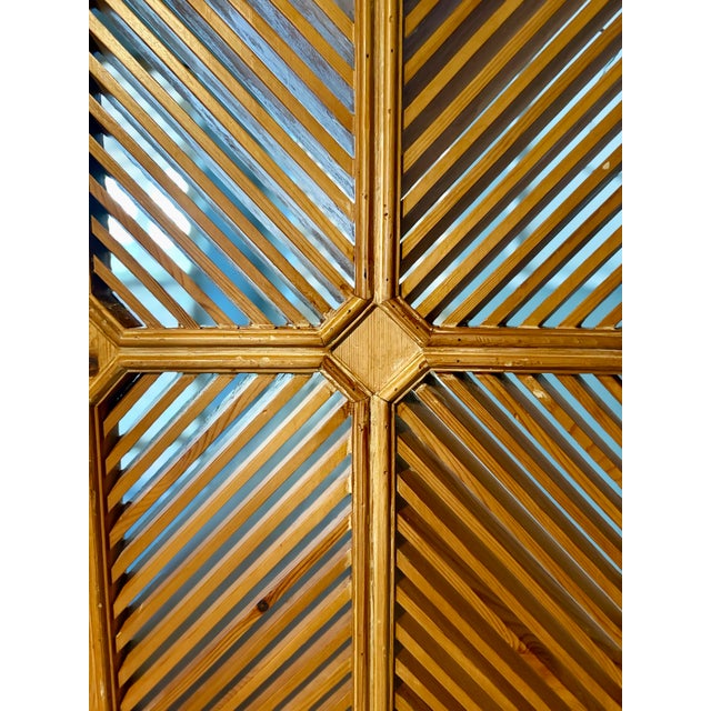 A striking 1977 Chapman Manufacturing Company three-panel folding screen, showcasing the distinctive craftsmanship and...