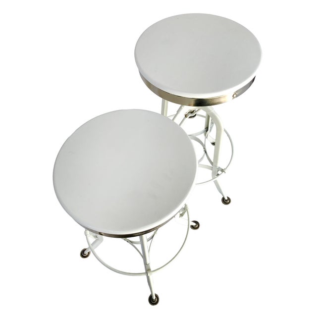 Pr. Of Vintage Restoration Hardward Adjustable White Stools. Industrial Style in metal and painted white base. with foot...