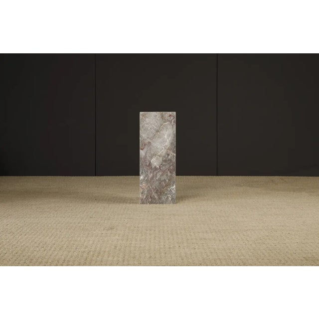 This beautiful 1980s Post-Modern exotic marble column pedestal features exotic graining and coloration with hues of grey,...