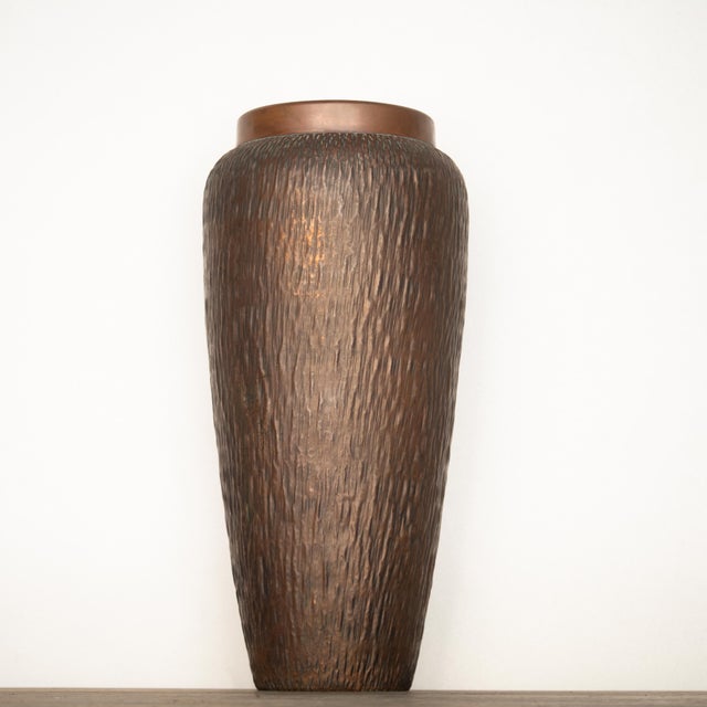 A hammered copper umbrella stand. Made in Italy in the 1970s. Brutalist design. In good overall condition, with normal...