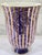A striking Jonathan Adler Malachite Stripe Urn Vase in purple, with a swirling, malachite-inspired pattern and bold...
