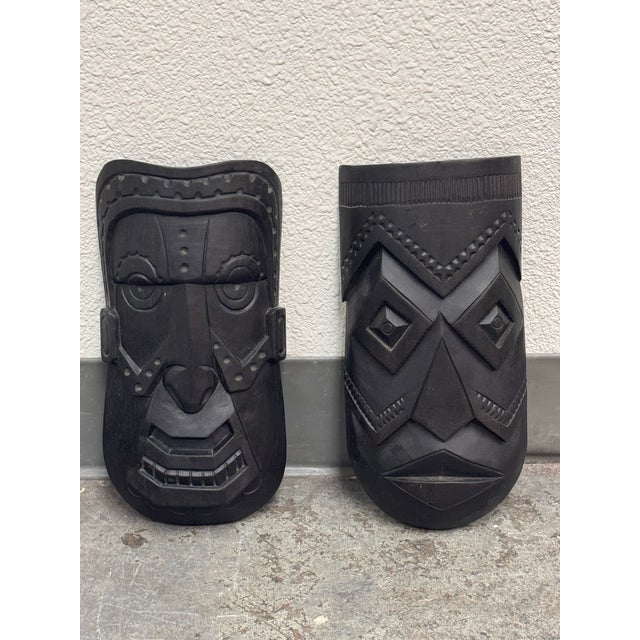 Design Plus Gallery presents a Pair of Hand Carved Native Wall Masks by Akios Industries. The masks have bold geometric...