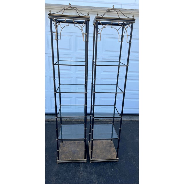 A striking pair of vintage metal and glass étagère display cabinets by on Art & Commerce of Dallas, Texas. Both units...