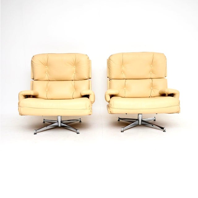 A magnificent pair of vintage leather and chrome ‘Kohinoor’ swivel armchairs by Howard Keith. They were made in England,...