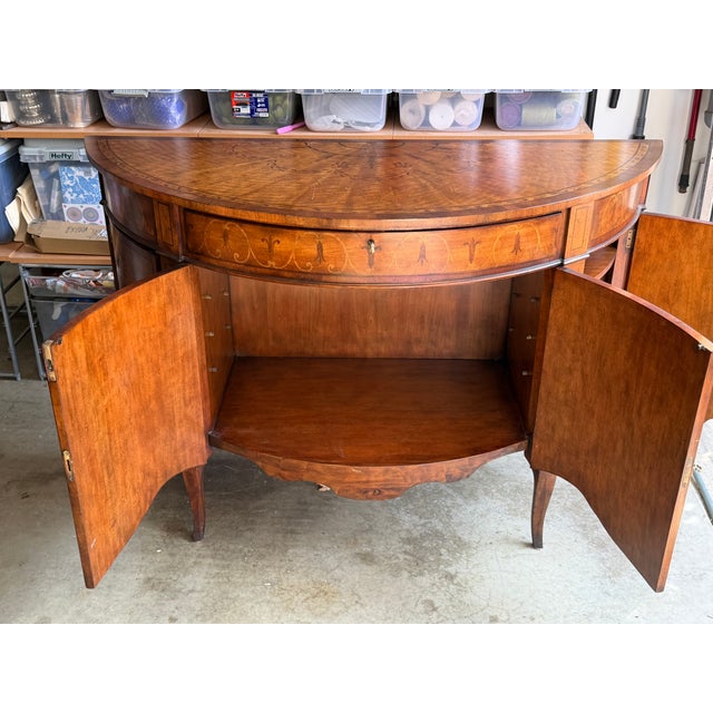 A George III style demilune console cabinet by John-Richard, from their European Crossroads Collection. Mahogany with...