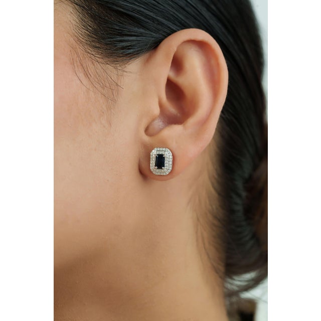 These art deco inspired stud earrings feature 1.46 carats of natural octagon-cut blue sapphires, set in 14K white gold....