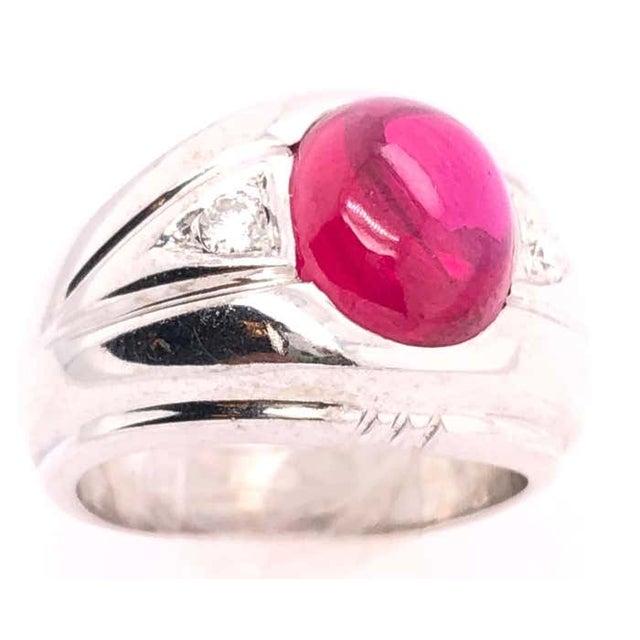 14 Karat White Gold Dome Ring With Garnet Cabochon And Diamond Accents 0.25 total diamond weight. Size 6.25 11.95 grams...