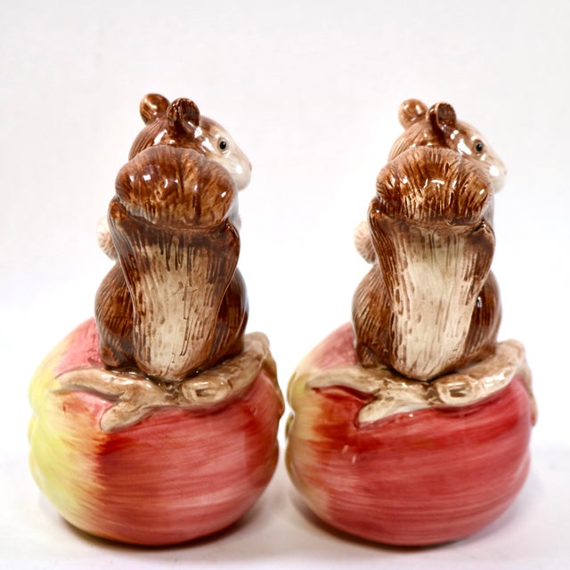 A pair of candle holders from Fitz and Floyd under their OCI Omnibus division. They feature hand-painted brown squirrels...
