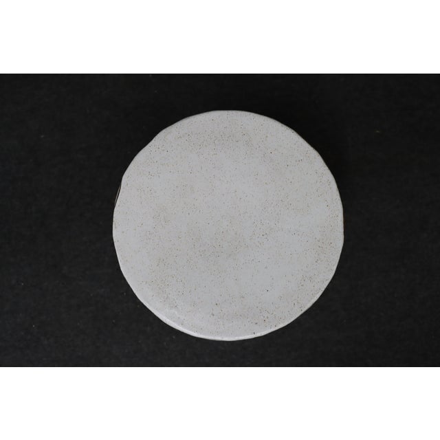 MCM ceramic stool with geometric pattern.