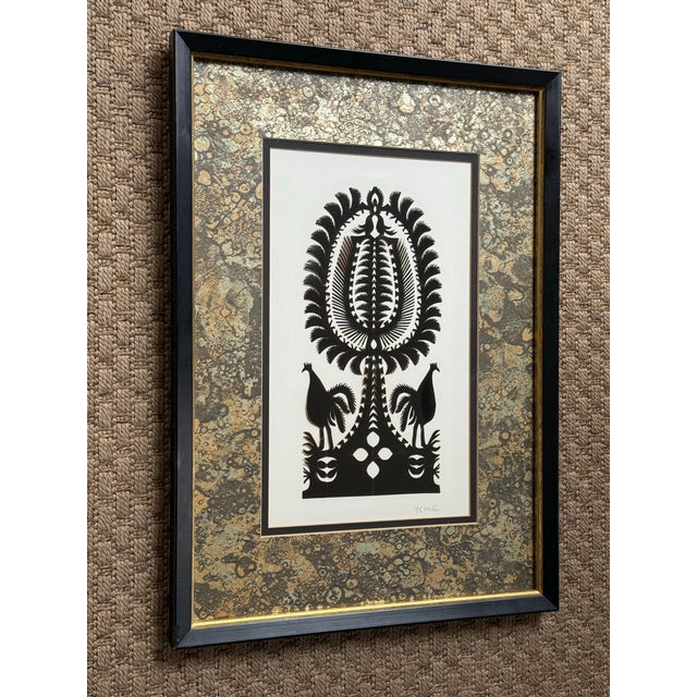 Vintage 1980s black kirigami paper cutting with birds under the Tree of Life. Intricate and beautifully contrasted against...