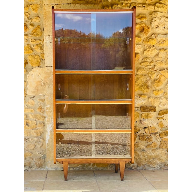Mid century, vintage bookcase with sliding glass doors, circa 1960's. piece is made of oak, with a beautiful, golden oak-...