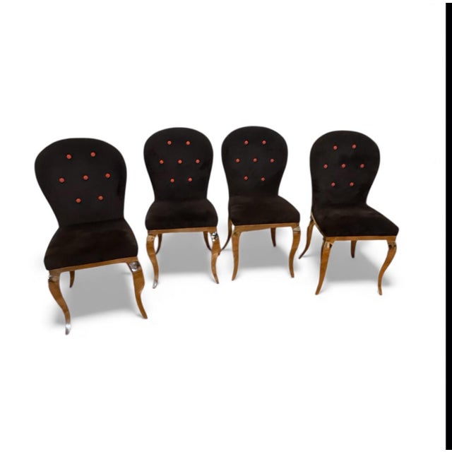 Striking set of four slipper chairs blending classic Hollywood Regency form with bold postmodern flair. Each chair...