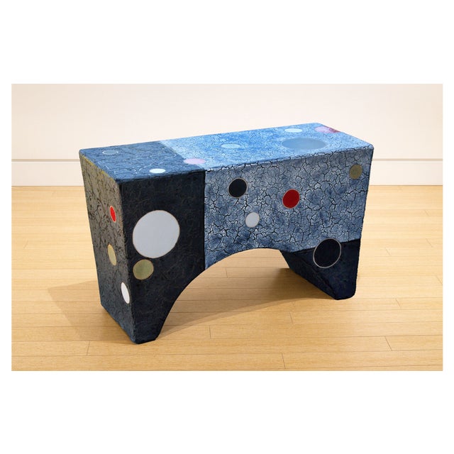 Solid and striking, this ceramic bench carries a deep grey-black ground, the reduction firing producing a surface that...