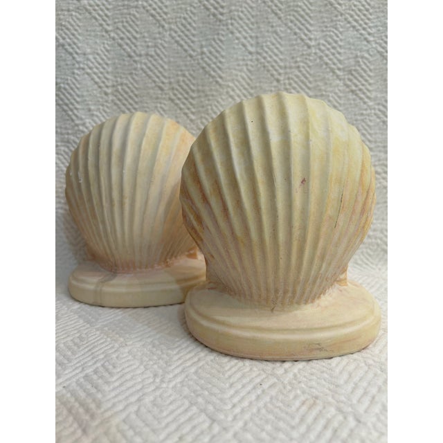 These clam shell bookends are made of plaster and have the softest pink glow. They are heavy enough to actually hold your...