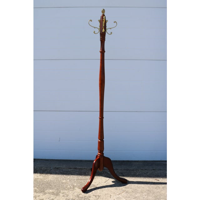 Beautiful freestanding mahogany coat rack with brass hooks and a brass pineapple finial attributed to The Bombay Company....